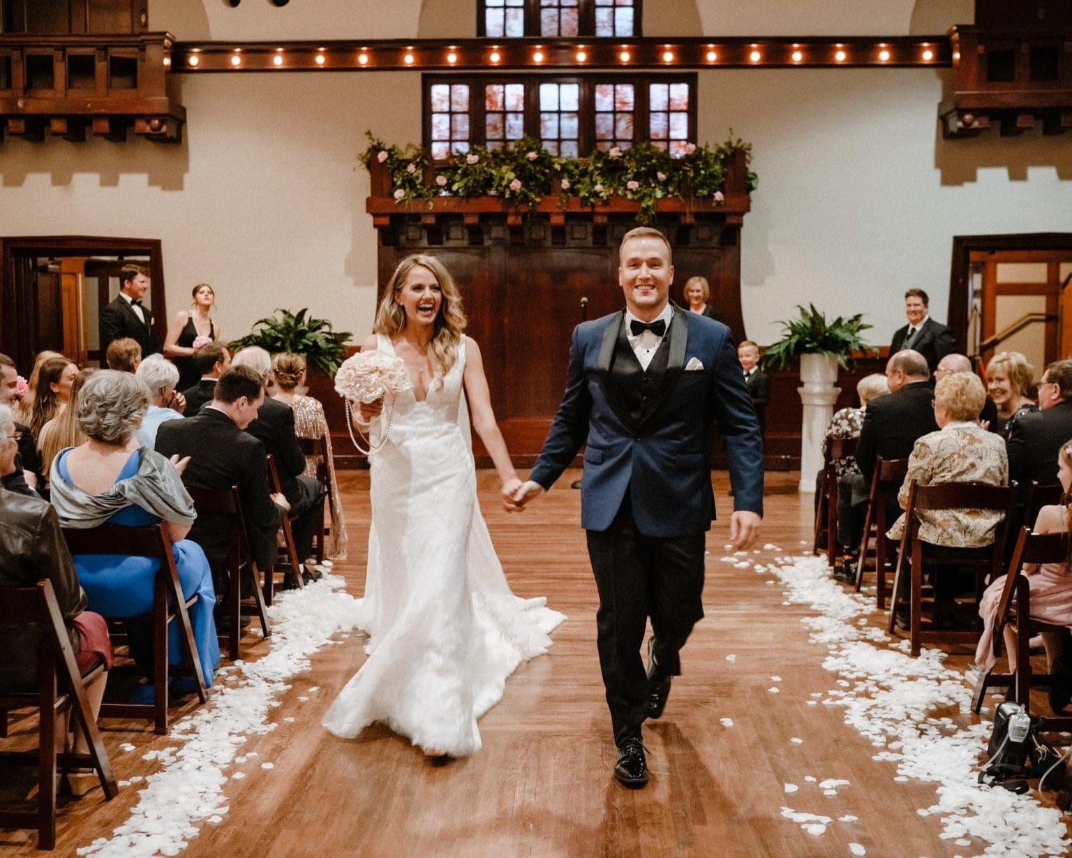 Montvale Event Center Theater event space with bride and groom walking back down the aisle