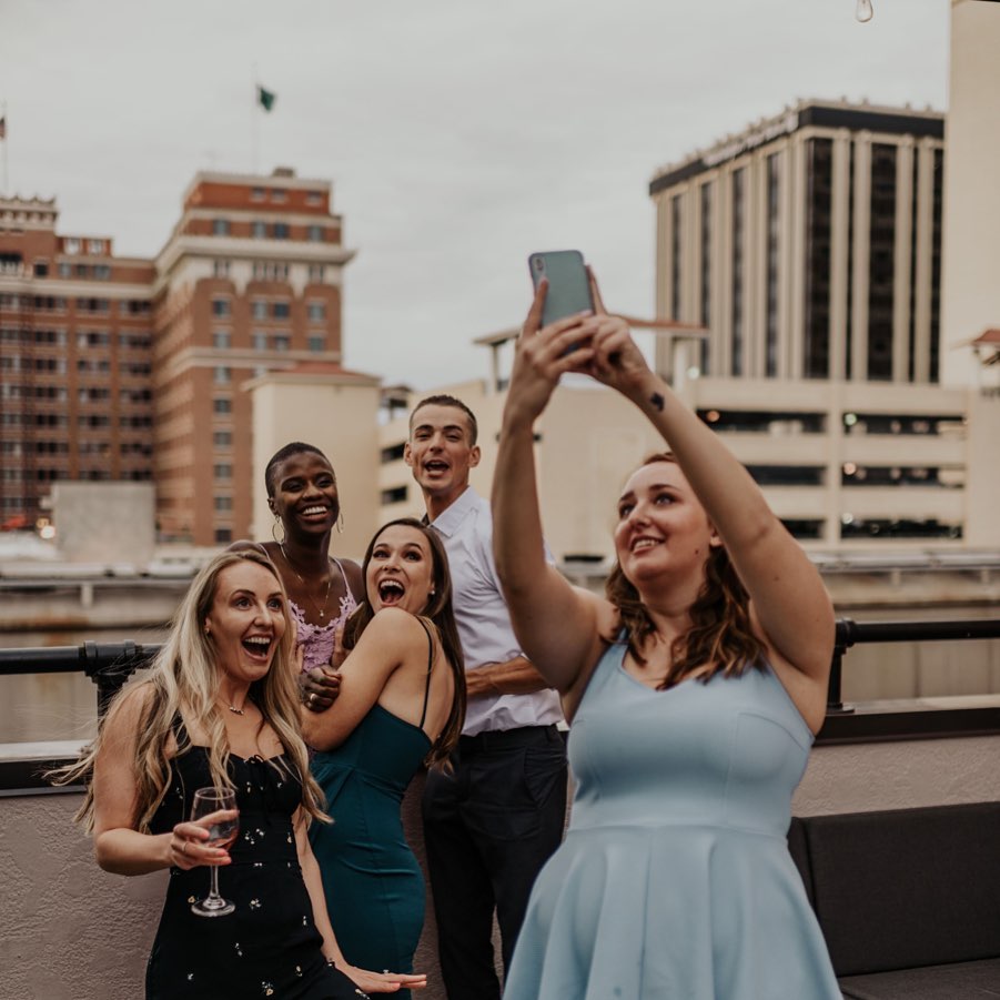 Friends taking a group selfie photo on Steam Plant Restaurant's Rooftop event space